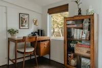 a tiny home office with a desk and bookshelf